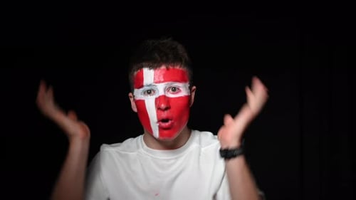 Enthusiastic Young Adult Cheering with Painted Face