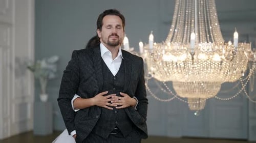 Elegant Man Embraced in Luxurious Indoor Setting