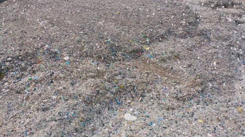 Aerial view of stack of different types of large mountain garbage pile, plastic bags, and trash