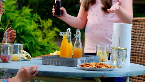 Childrens party.Children open fruit drinks in a summer sunny garden. summer drink.