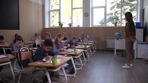 Enthusiastic Children Engaging with Teacher in Classroom