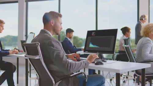 Employees Working at Computers in Modern Office