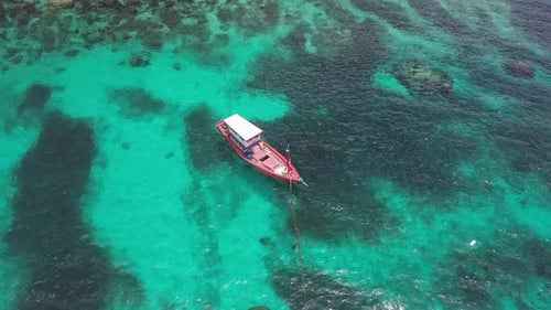 Boats Anchoring in Turquoise Shallow Water By the Edge of Coral Reef. Aerial View