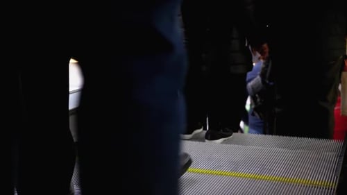 Legs of People Moving on an Escalator Lift in the Mall. Shopper's Feet on Escalator in Shopping