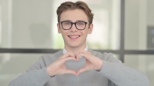 Young Adult Making Heart Shape With Hands