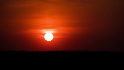 Dramatic Sunset Through the Clouds Above the Horizon. Timelapse.