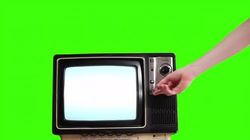 Woman’s Hand Turning On Retro TV with Blue Screen Against Green Background – 4K