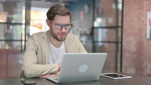 Young Adult Man Communicating via Video Conference