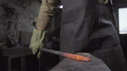 Blacksmith Forging Red Hot Metal on Anvil