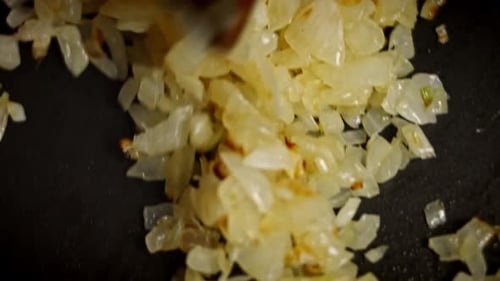 Chopped Onions Sizzling in a Frying Pan