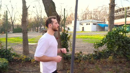 The athlete is running in the park.