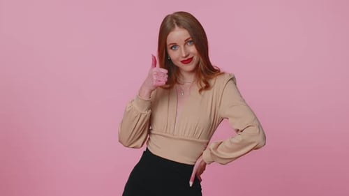 Cheerful Woman Giving Thumbs Up on Pink Background