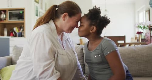 Affectionate Mother and Child Touching Foreheads on Couch