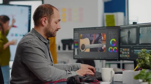 Man Editing Video in Modern Office Workplace