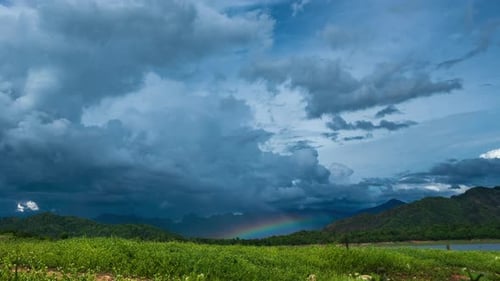 time-lapse of tropical forest, sunset over the mountain and lake with rainbow