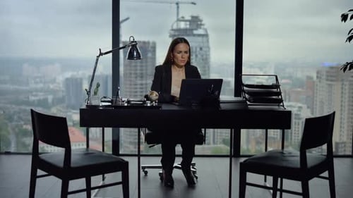 Businesswoman Working on Laptop in Office. Female Employee Using Laptop Computer