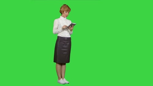 Pretty Young Woman Using Tablet on a Green Screen, Chroma Key