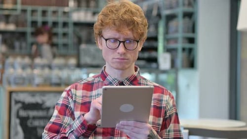 Young Adult Using Tablet Indoors