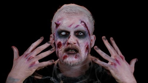 Intense Zombie with Gore Makeup Stares Into Camera