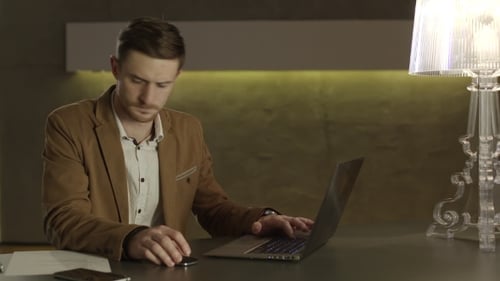 Young Adult Working on Laptop in Office