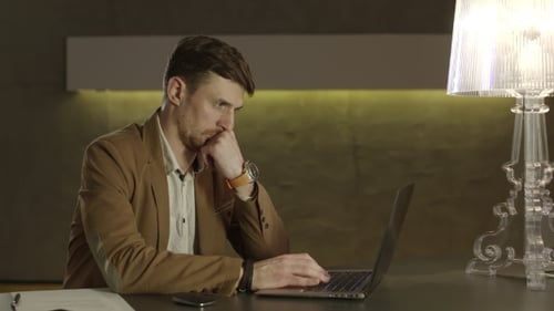 Man Working on Laptop Computer at Desk