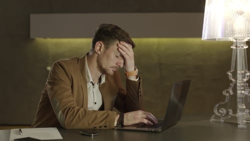 Businessman In a Hotel Dropping His Head With Tiredness.