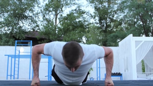 Muscular Man Does Push-ups Outside