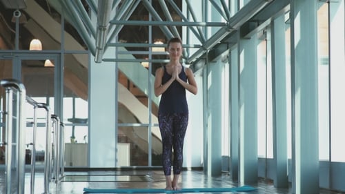 Girl Join Palms In Front Of The Chest Level. Tree Pose In Yoga