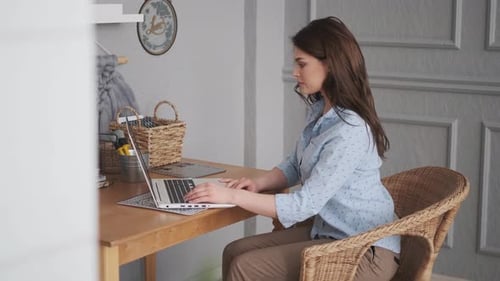 Girl Freelancer Working at Home. Young Woman at Home Studio Working on Laptop