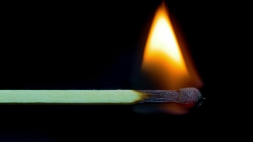 Macro Shot of a Match Burning on Black