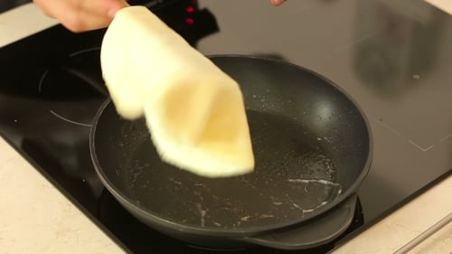 Pancake Batter Cooks in Frying Pan on Stove