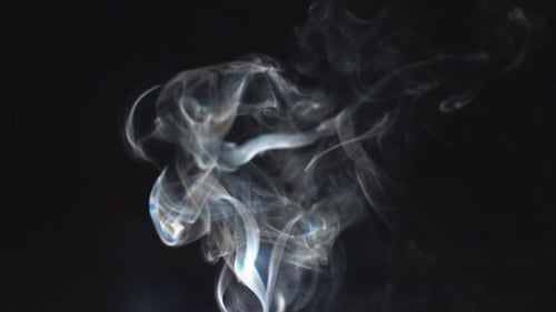 Wispy Smoke Flowing on a Black Background