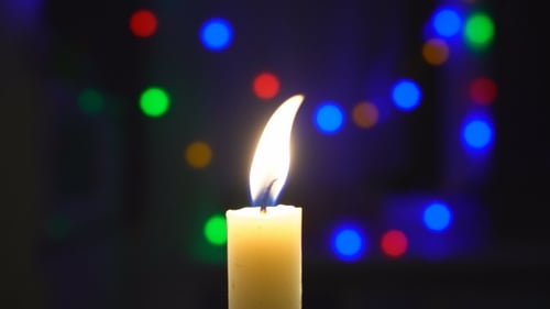 Burning Candle Extinguished with Smoke and Bokeh Lights