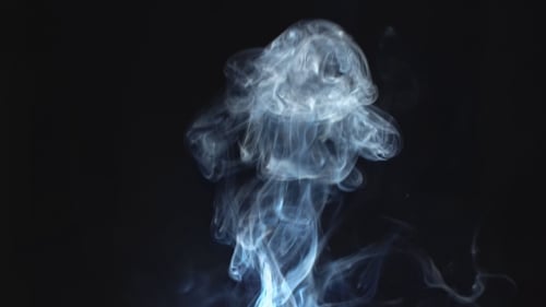 Rising White Smoke Against Black Background