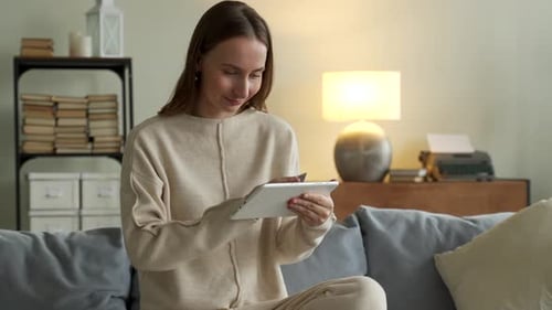 Smiling Woman Couch Using Tablet To Shop Online Home Living Room