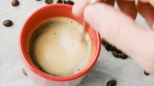 Stirring Coffee in a Red Mug Close Up