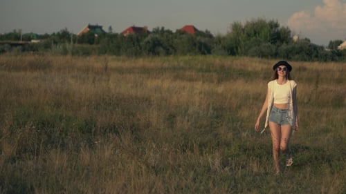 Young Beautiful Woman Model Walking On The Meadow And Enjoying The Nature