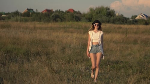 Young Beautiful Woman Model Walking On The Meadow And Enjoying The Nature