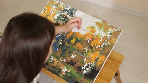 Woman Painting by Numbers on Canvas at Home