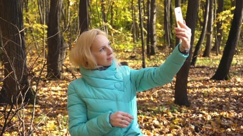 Beautiful Girl Makes Selfie In The Autumn Forest