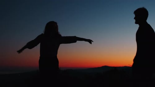 Romantic Couple Embracing in Sunset Silhouette
