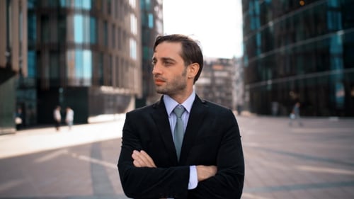 Portrait Of Young Businessman Crossing Hands