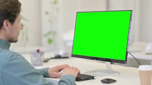 Man using Desktop with Green Chroma Key Screen