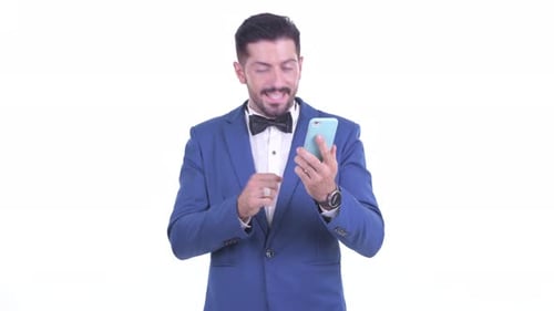 Man in Suit Celebrates Success on Cell Phone