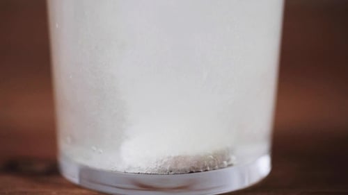 Effervescent Tablet Dissolving in Glass of Water