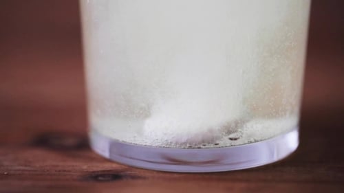 Effervescent Tablet Dissolving in Bubbling Glass of Water