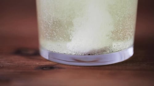 Effervescent Tablet Dissolving in Glass of Water