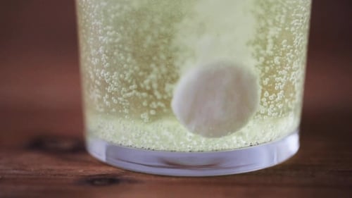 Effervescent Tablet Dissolving in Glass of Water