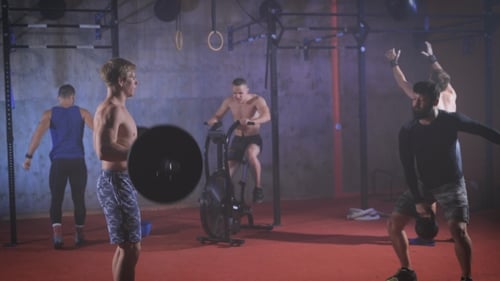 Five Strong Athletes Doing Group Crossfit Training At The Gym.
