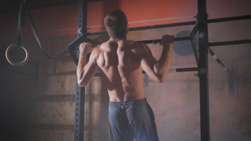 Young Muscular Athlete Doing Pull-up Exercises.